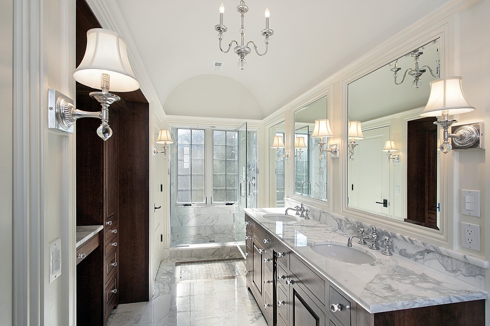 Bathroom with white marble top and dark wood cabinets