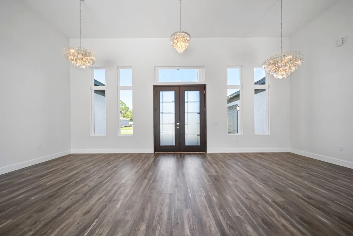 Grand entryway with crystal chandeliers and double front doors