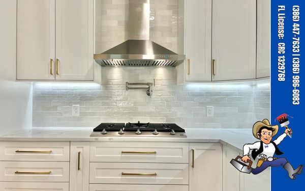 Gray tile kitchen backsplash with white cabinets