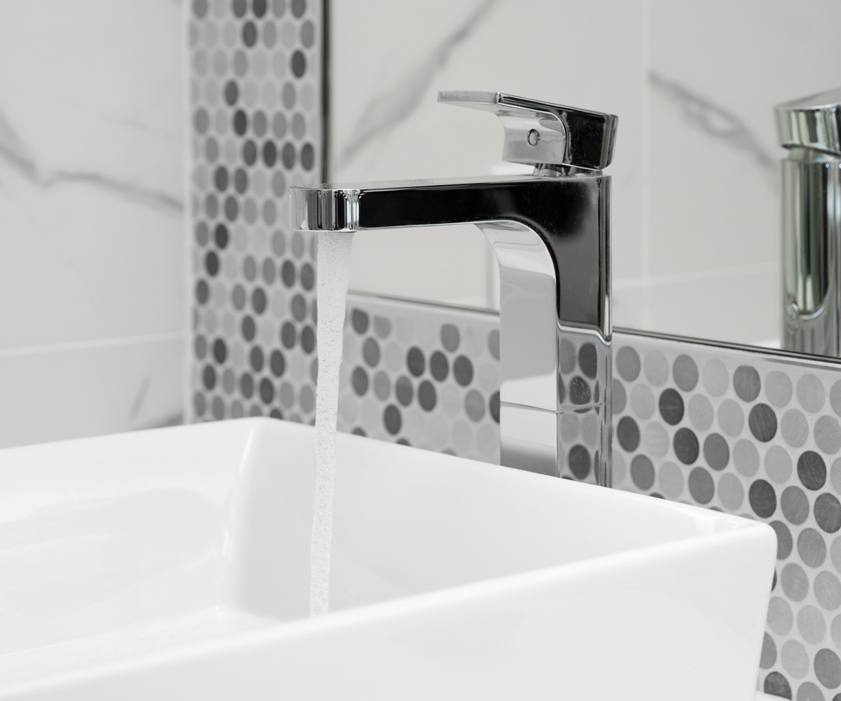 Mosaic tile wall behind a freestanding tub