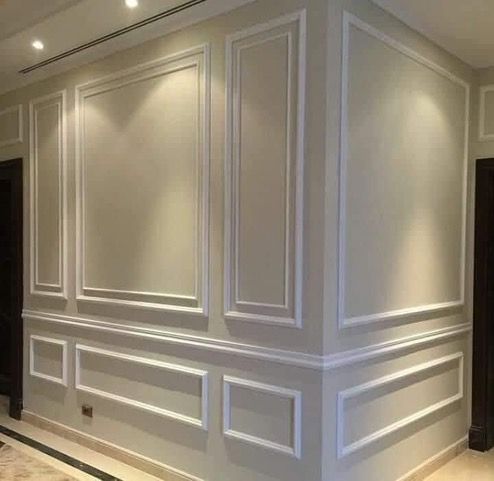 Gray shadowbox and wainscoting wall treatment in a hallway