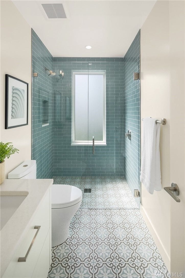 Turquoise tile shower with glass door