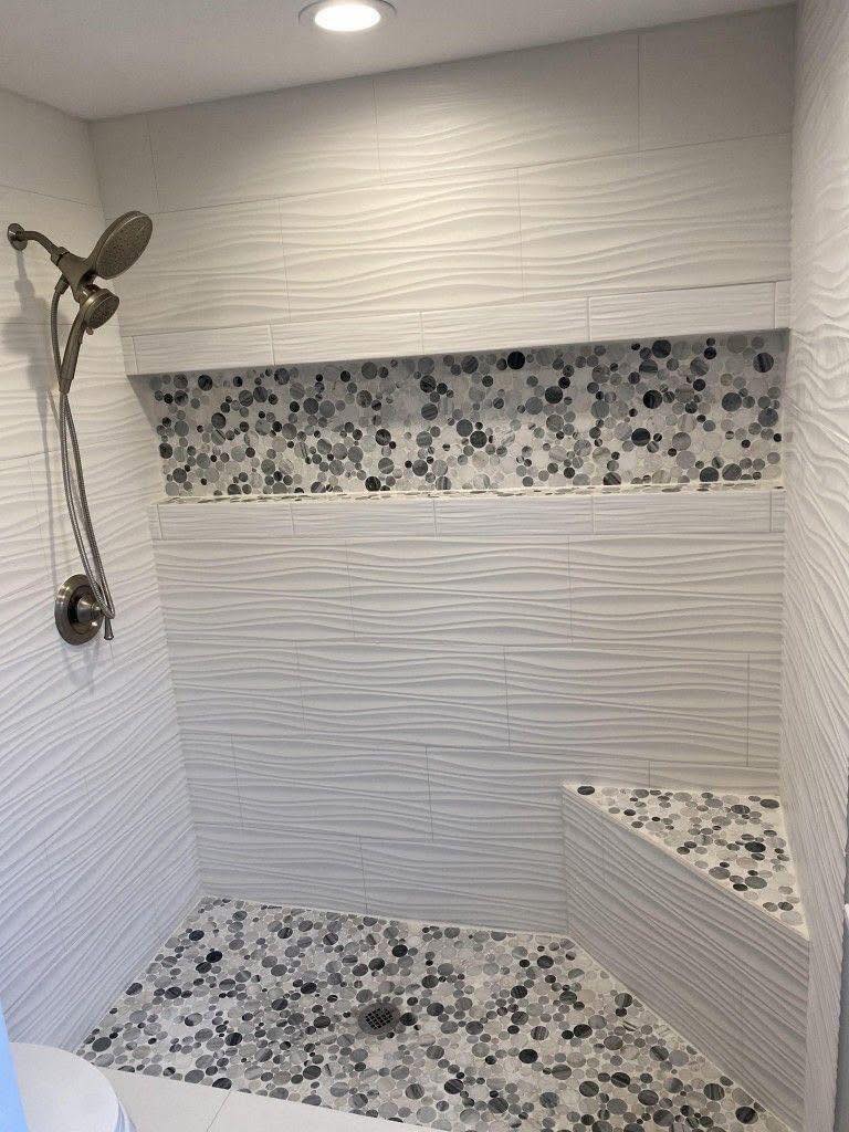 Wave-pattern white tile shower with glass door